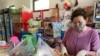 Kazakhstan - A shop assistant serving people. Myrzatay village. 28 March 2020